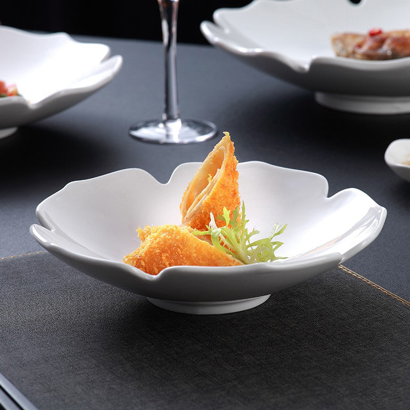 White ceramic plate with a modern petal-shaped design, perfect for elegant food presentation and fine dining settings