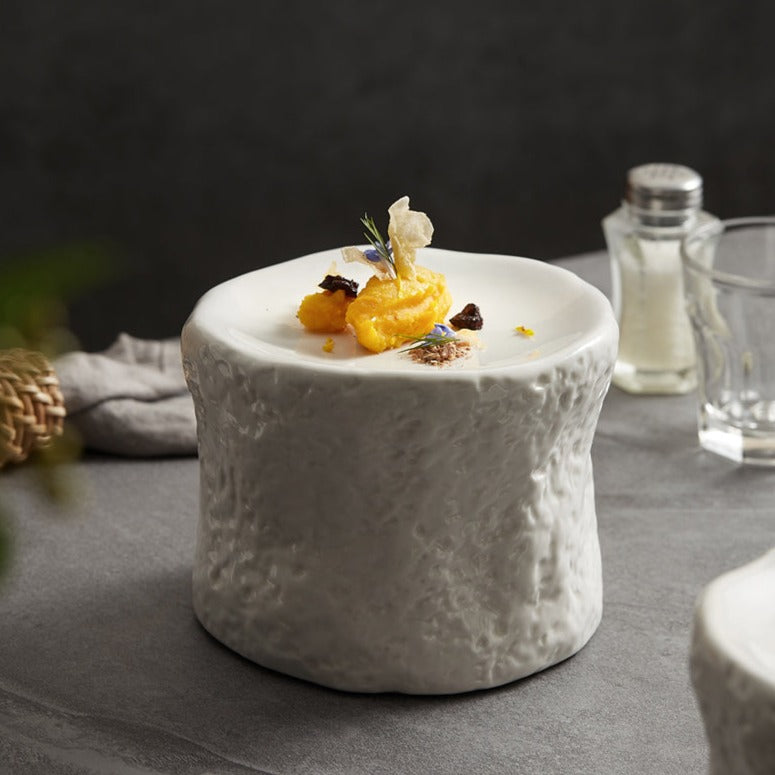 White ceramic plate with a unique cylindrical design and textured exterior, perfect for creative food presentations and modern fine dining.