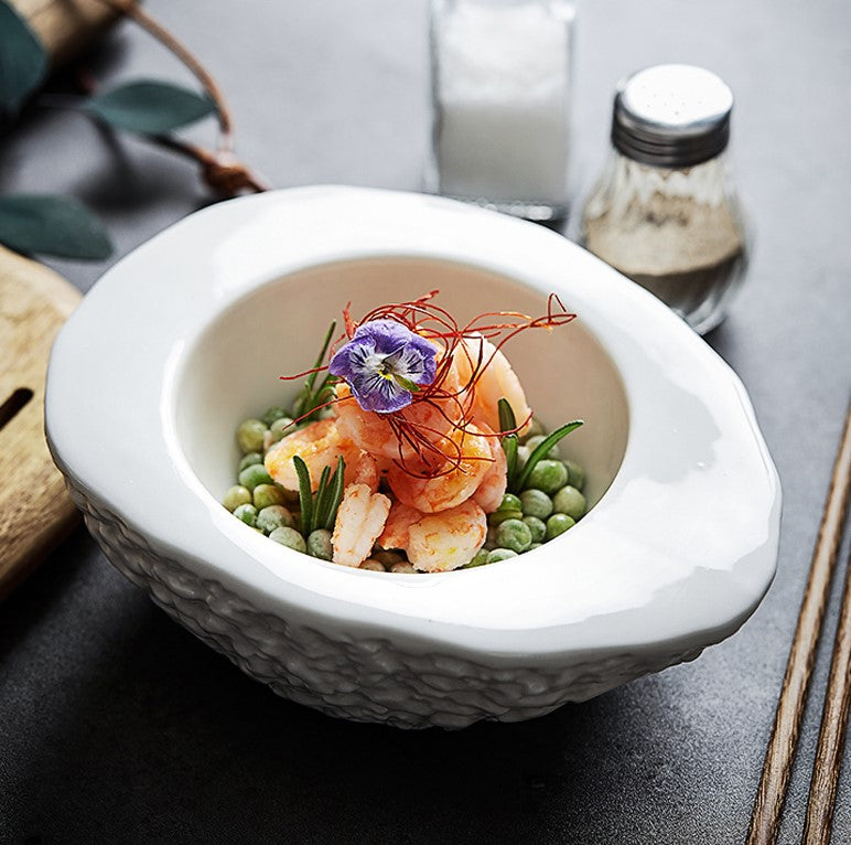 White textured ceramic bowl with an irregular, modern design, perfect for presenting gourmet dishes in fine dining settings